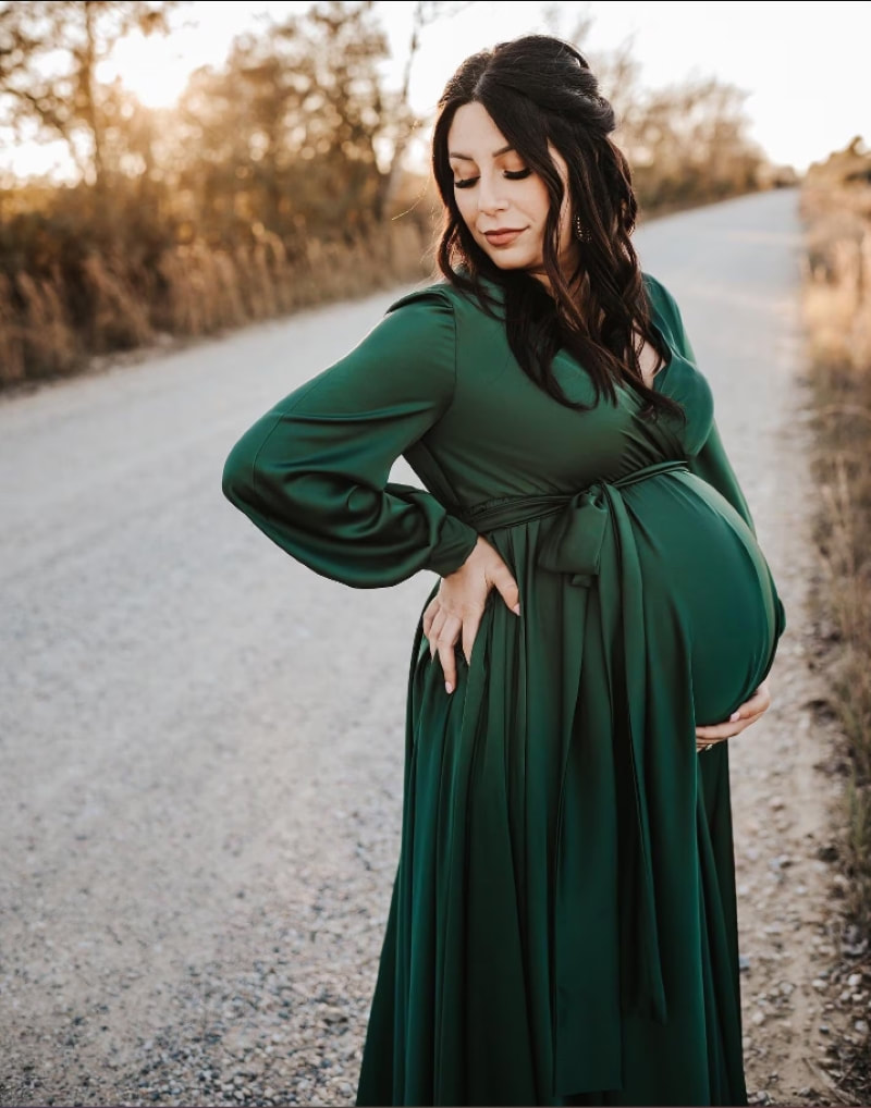 pregnant woman wearing green formal maternity dress